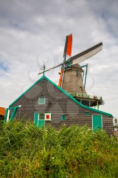 Traditional, authentic dutch windmill in Zaanse Schans village.