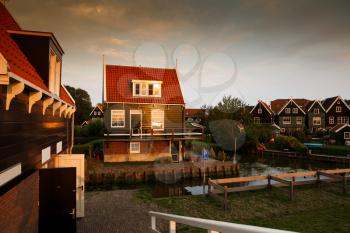 The old traditional colorful houses at the canal in the Dutch fisherman village at the sunset.