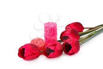 Candles and tulips isolated on white background.