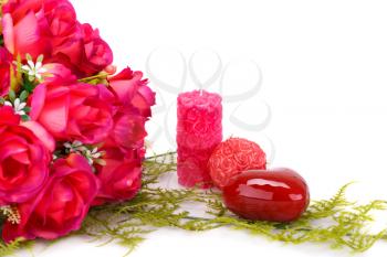 Candles, roses and glass heart  isolated on white background.
