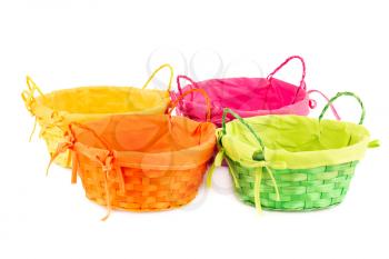 Four colorful empty wicker baskets isolated on white background.