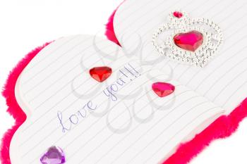 Red hearts on opened notepad on white background. Inscription Love You.