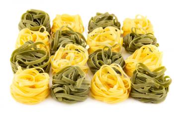 The heap of tagliatelle pasta isolated on white background.