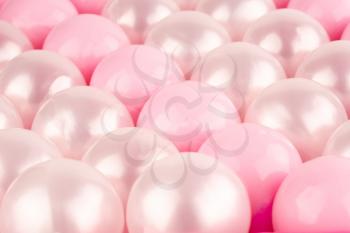 Pink and white plastic balls as a background.