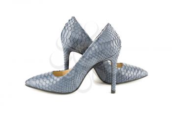 The pair of stylish high heels python leather shoes isolated on white background.