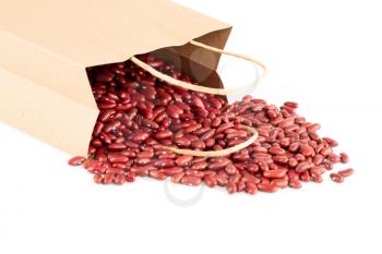 Red kidney beans in the paper bag on a white background.