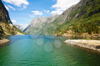 Landscape with mountains and fjord in Norway, sunny day, view from Gudvangen.