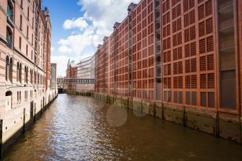 Canal from Elbe river, bridge and buildings at Speicherstadt (Warehouse) district in Hamburg, Germany.