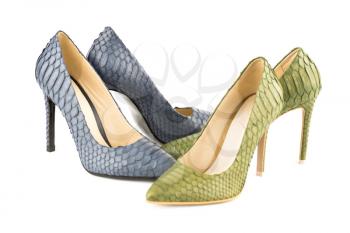 Two pairs of stylish high heels python leather shoes isolated on white background.