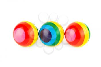 Three colorful striped rubber balls isolated on white background.