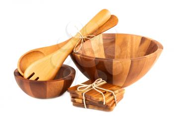 Wooden bowls, spoon, fork and coasters isolated on white background.