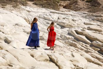 Blond women walking on the white rock in Cyprus.