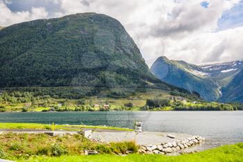 Landscape with mountains, fjord and village in Norway.