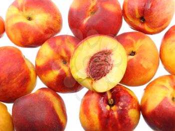 A heap of peaches with cutting of one, on white background. Isolated