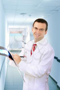 Friendly medical doctor stand in Hospital corridor.