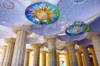 Hall with mosaic sun at ceiling, at Guell Park, Barcelona, Spain.