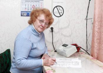 Woman dispatcher on the big industry plant, near console.