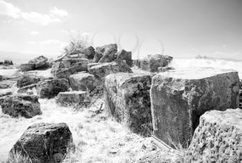 The big square stones which have remained after building of an ancient temple. Pamukkale. Turkey