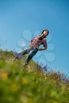 beautiful woman in jeans standing on the grass