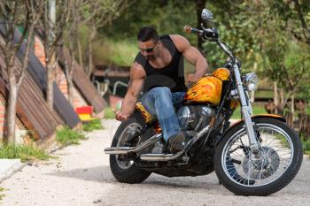 Biker Man Bodybuilder Sits On A Bike