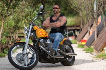 Biker Man Bodybuilder Sits On A Bike