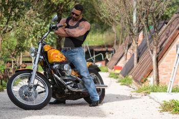 Biker Man Bodybuilder Sits On A Bike