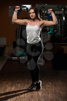 Young Woman Working Out With Kettle Bell