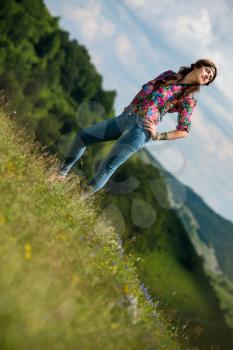 beautiful woman in jeans standing on the grass