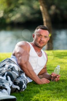 Bodybuilder Holding Water Bottle