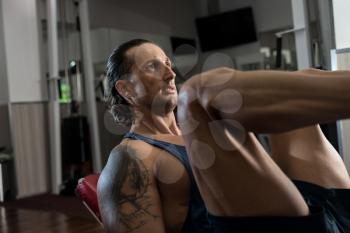 Man in gym on machine exercising