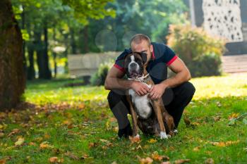 Man Playing With Dog In Park