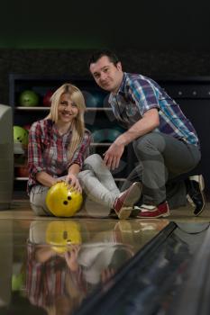 Man Teaching Woman Bowling