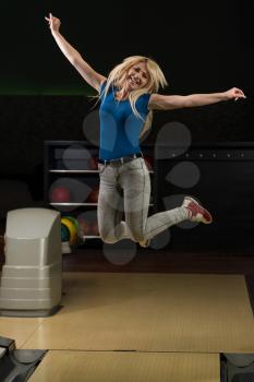 Ecstatic Bowling Women With Raised Hands