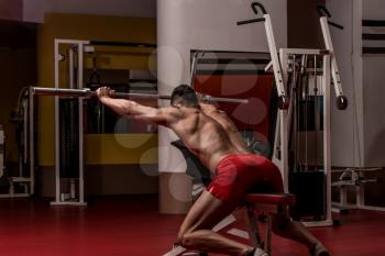Bodybuilder Doing Heavy Weight Exercise For Shoulders