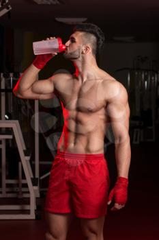 Muscular Men Drinking Water From Shaker