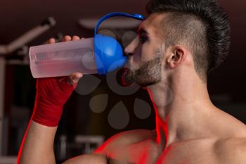 Muscular Men Drinking Water From Shaker