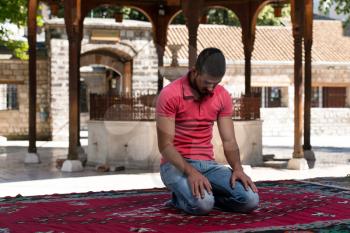 Muslim Man Is Praying In The Mosque Outdoors