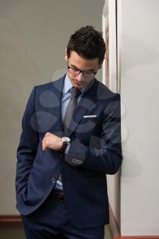 Young Businessman Looking At The Time On His Wrist Watch