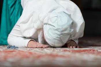 Young Muslim Woman Praying In Mosque