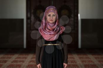 Young Muslim Woman Praying In Mosque