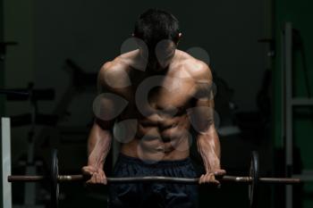 Muscular Man Doing Heavy Weight Exercise For Biceps