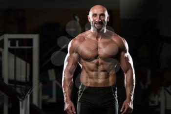 Portrait Of A Physically Fit Mature Man In A Healthy Club With Dramatic Lighting