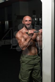 Mature Bodybuilder Exercise In The Gym - He Is Performing Two Arm Biceps Push Up