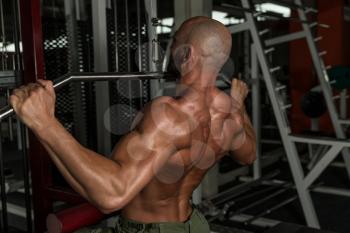 Mature Man Doing Back Exercises In The Gym