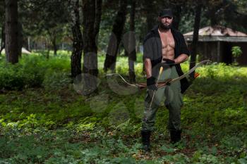 Beard Man With A Bow And Arrows In The Woods