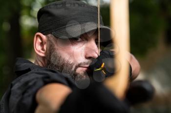 Beard Man With A Bow And Arrows In The Woods