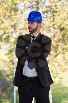 Portrait Of Business Man With Blue Helmet On Construction