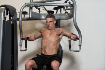 Muscular Man Doing Heavy Weight Exercise For Chest