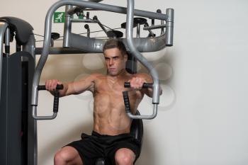 Muscular Man Doing Heavy Weight Exercise For Chest