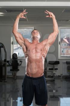 Portrait Of A Physically Fit Man Showing His Well Trained Body In Gym